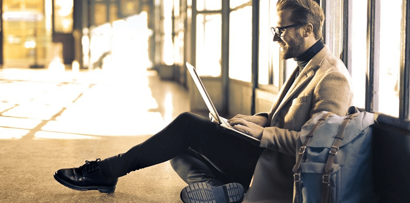 happy man using a laptop