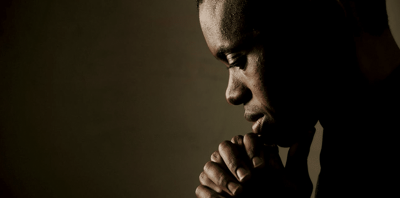 man silently praying