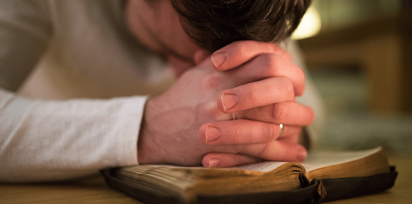 man praying silently