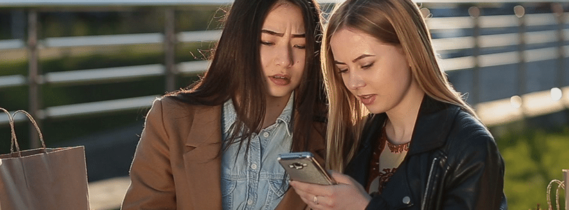 women inspecting a browsing site