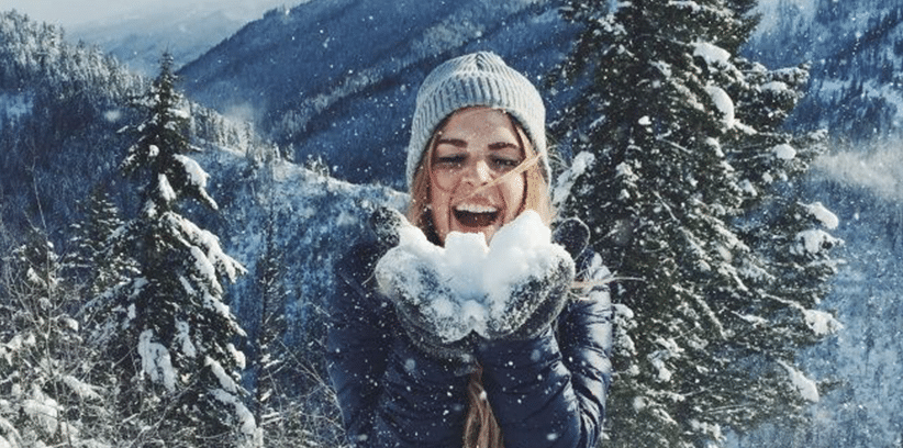 happy woman blowing snow