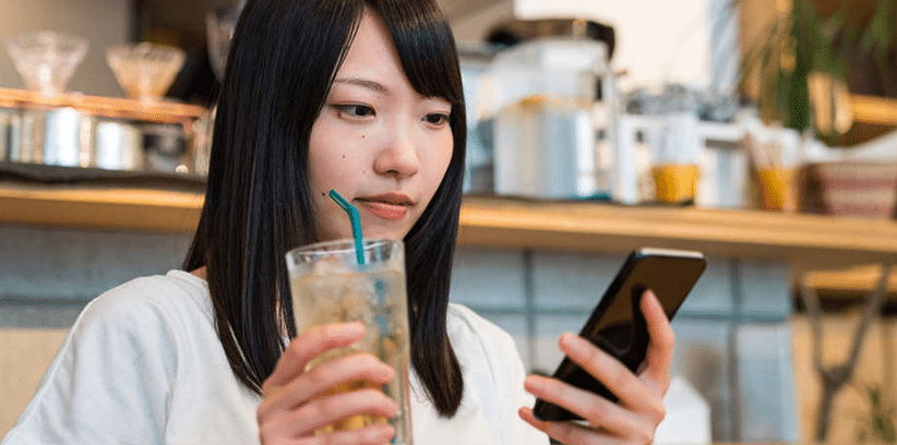 woman chatting with someone using smartphone