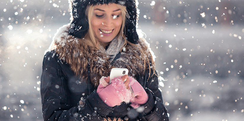 smiling woman using smartphone