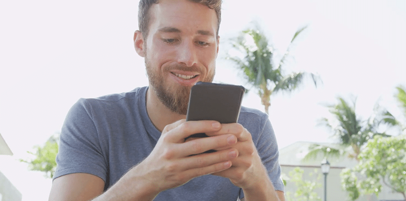 happy man using his smartphone