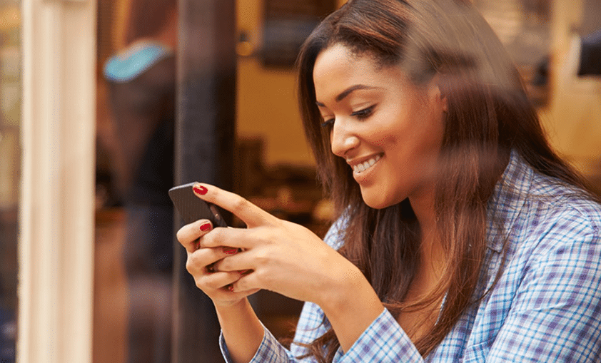 happy woman using her smartphone