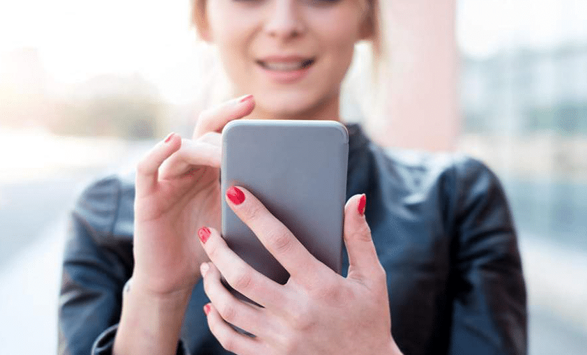 woman chatting with someone using smartphone