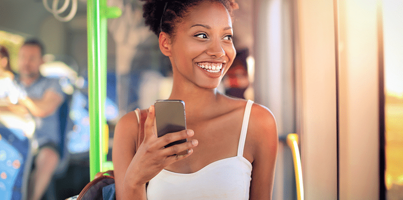happy woman chatting with someone through smartphone