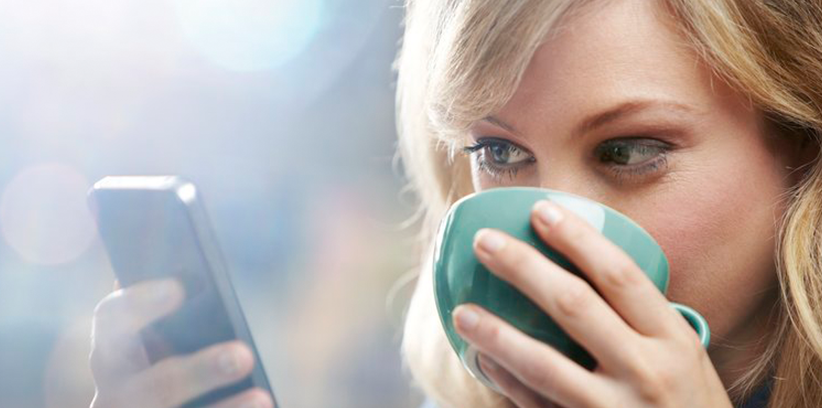 happy woman chatting with someone through smartphone