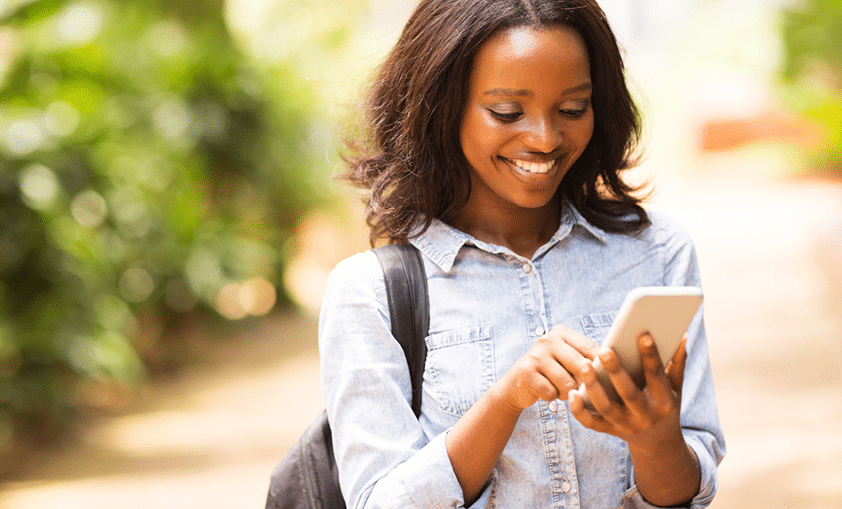 happy woman chatting with someone through smartphone