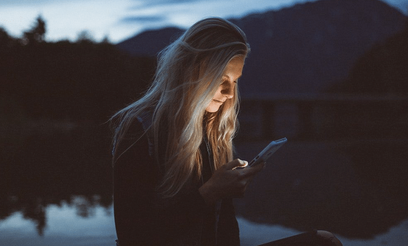 woman looking through her phone