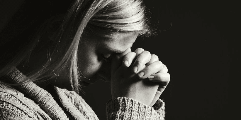 sad woman praying