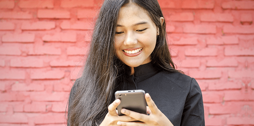 happy teen woman chatting with someone else