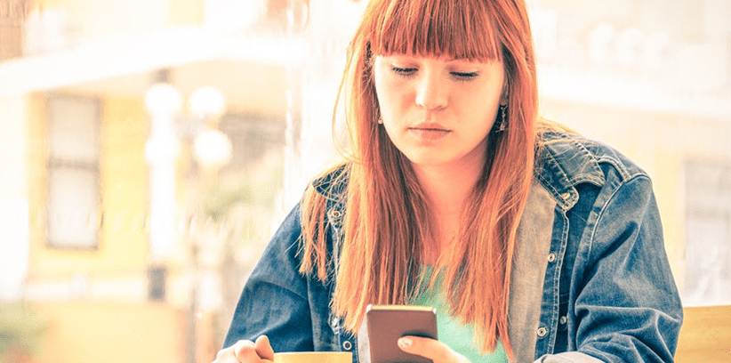 serious woman using her smartphone